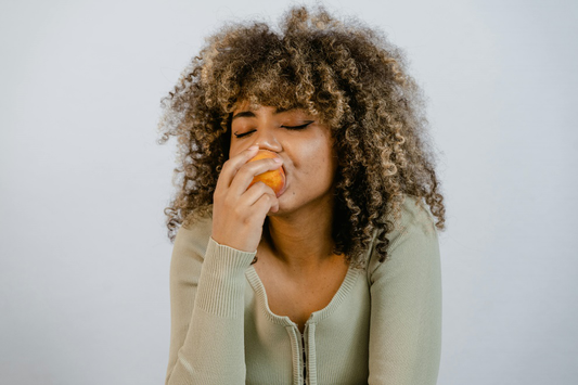 Woman holding onto a fruit